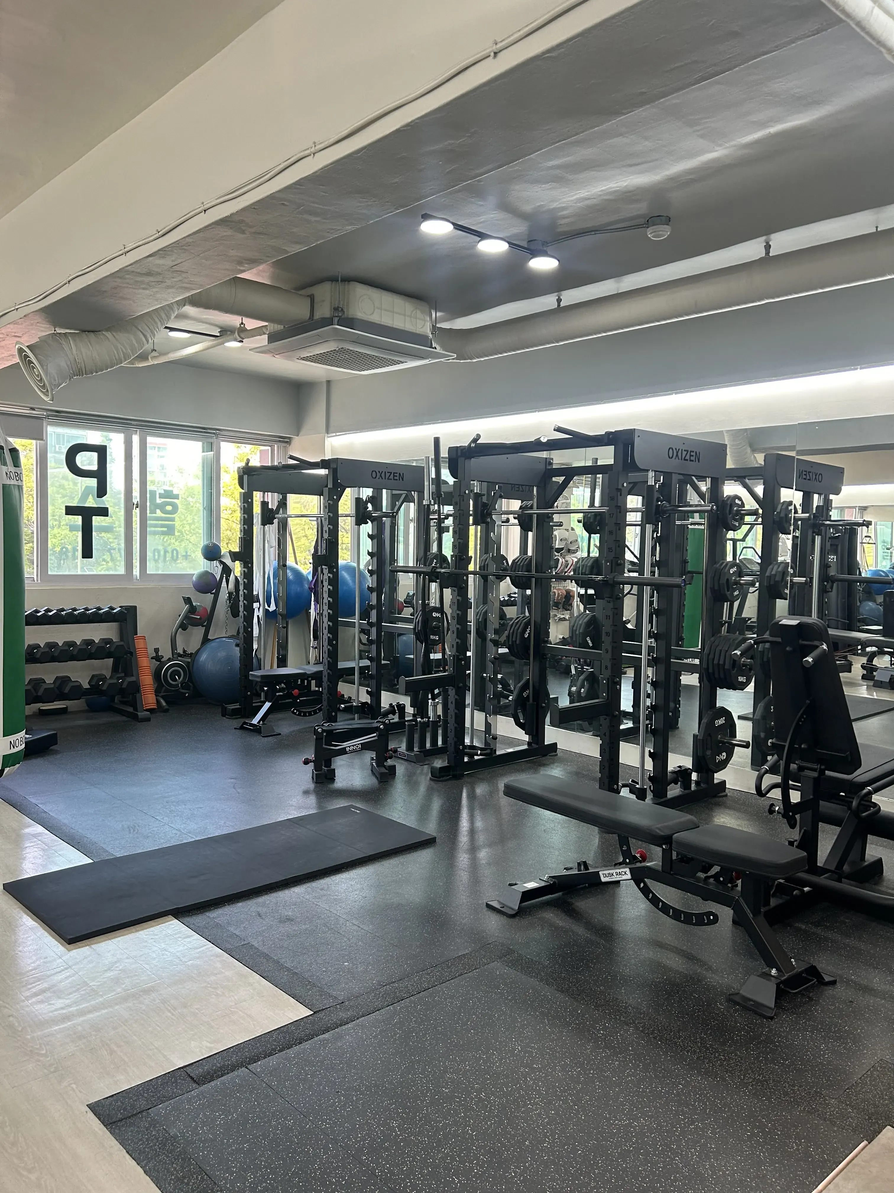 BODY SMITH private gym space with boxing, conditioning, and weight training equipment